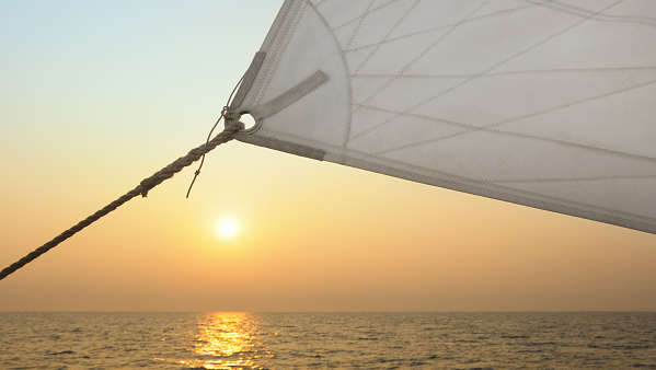 Yacht sail at sunset