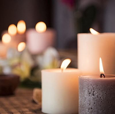 Collection of flickering pillar candles in different heights and colours