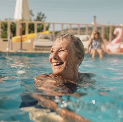 Retired women smiling in a pool