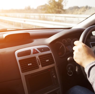 Front passenger view of a man at the steering wheel on a motorway Front passenger view of a man at the steering wheel on a motorway
