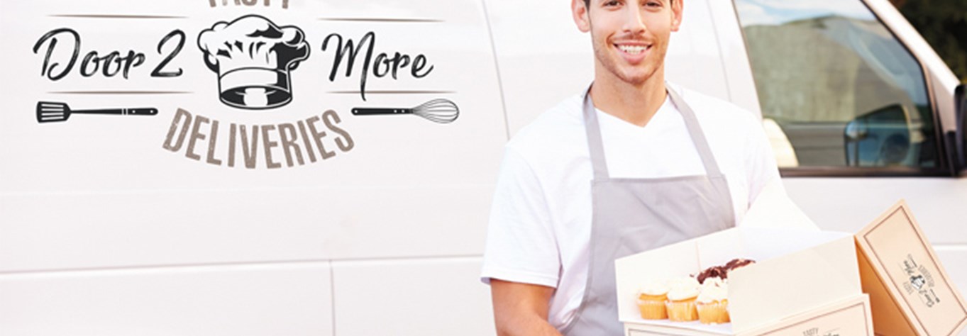 Smiling man holding boxes with cup cakes beside a cream van with TASTY Door 2 more DELIVERIES logo