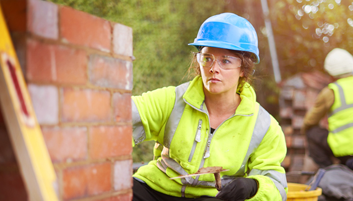 Female Builder And Wall