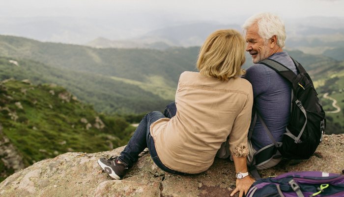 Older Couple Enjoying View From Top Of A Hill