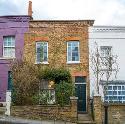 Staggered two floored, flat roofed terraced houses with brick walls on a slope Staggered two floored, flat roofed terraced houses with brick walls on a slope