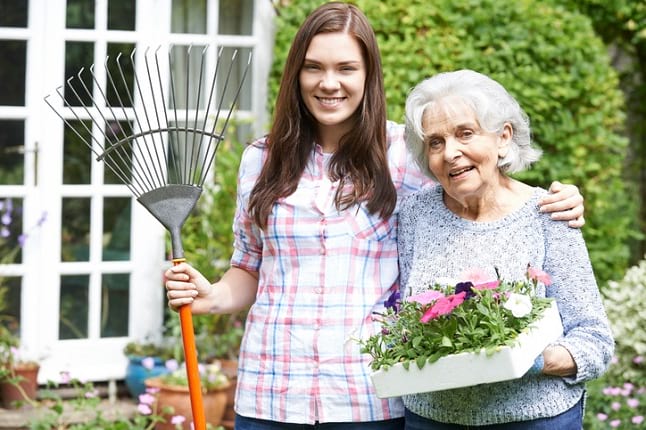 Elderly gardener with care worker