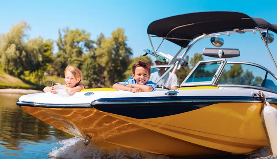 Two children relaxing in the sun on a boat