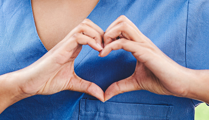 Hands In Heart Shape Over Scrubs