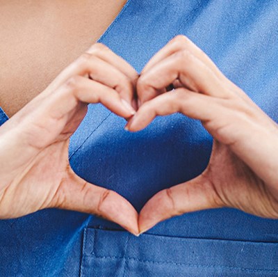 Hands In Heart Shape Over left chest of blue Scrubs Hands In Heart Shape Over left chest of blue Scrubs