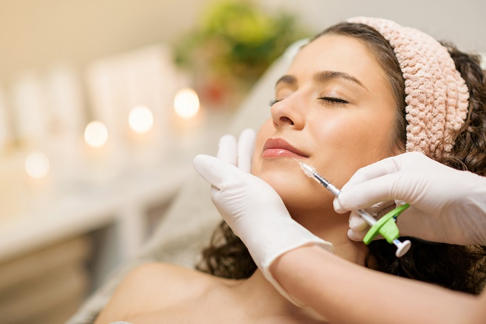 Aesthetics Woman Lying Down Getting Her Lips Injected