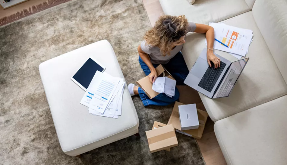 Woman working on her laptop in her living room