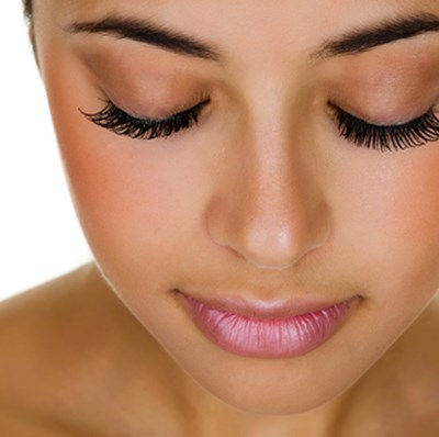 Face and shoulder shot of a women with long eye lashes Face and shoulder shot of a women with long eye lashes