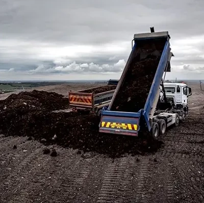 Tipper Truck With Raised Trailer Pouring Material On A Household Waste Area Tipper Truck With Raised Trailer Pouring Material On A Household Waste Area