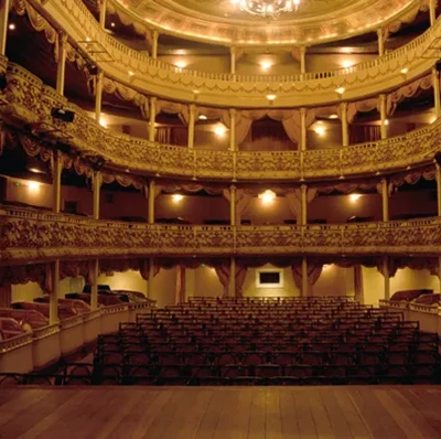 View from near the edge of the stage of old three storied theatre and chandelier 