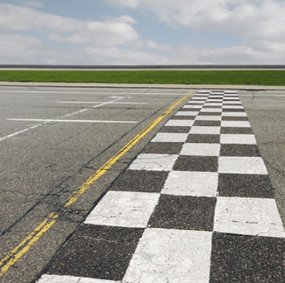 3 vertical rows of black and white checkers across tarmac with 2 strips of horizontal grass in the upper distance and white clouds in the sky 3 vertical rows of black and white checkers across tarmac with 2 strips of horizontal grass in the upper distance and white clouds in the sky