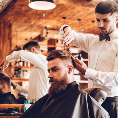 Man in a barbers having his hair cut