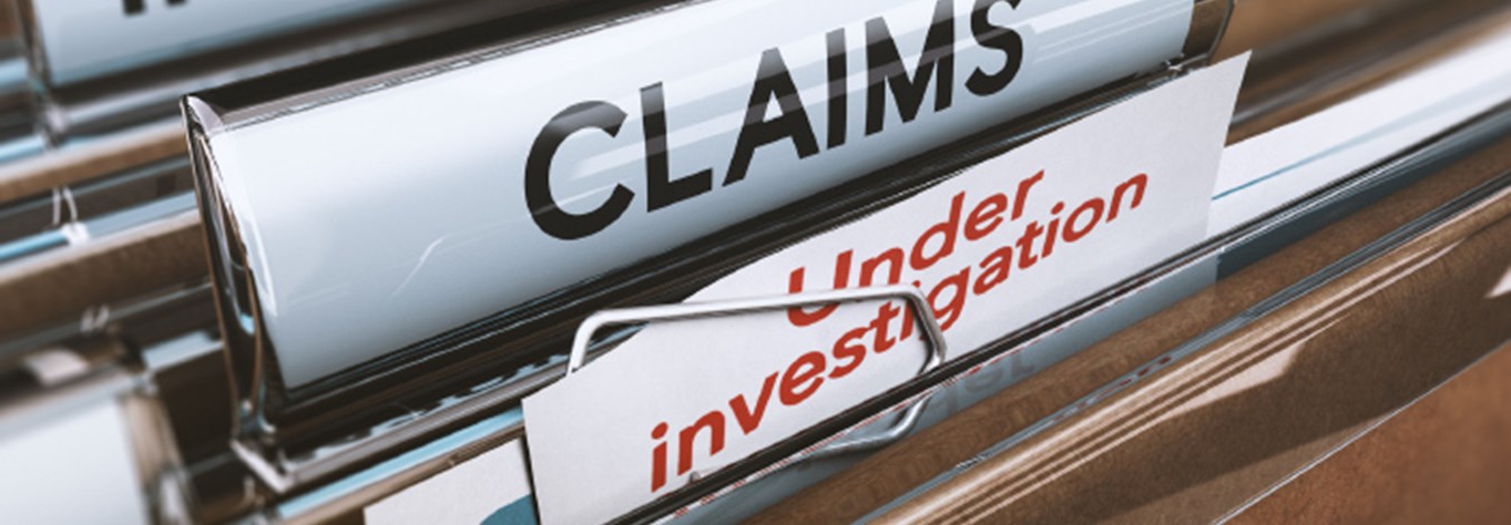 Tabs on files in a filing cabinet labeled "INSURANCE" "CLAIMS" and "UNDER INVESTIGATION"