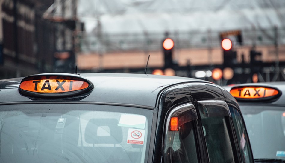 Two London black cabs on a cloudy day
