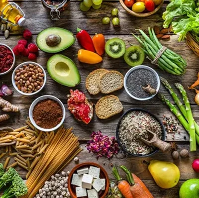 A range of colourful fruits, vegetables, whole wheat pasta and legumes A range of colourful fruits, vegetables, whole wheat pasta and legumes