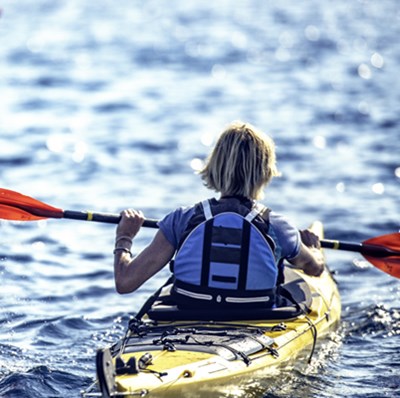 Back view of man and women canoeing  Back view of man and women canoeing