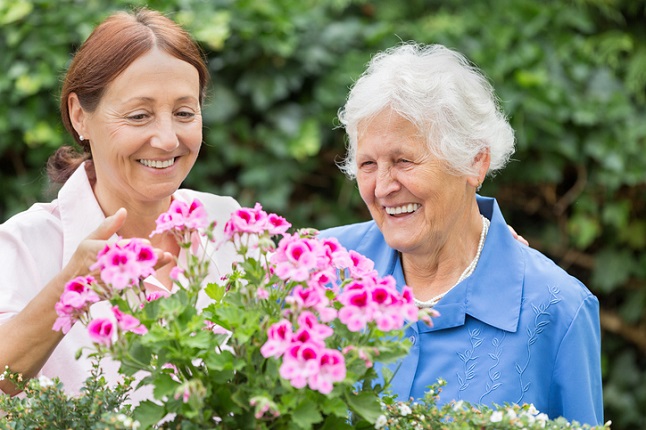 carer and woman gardening
