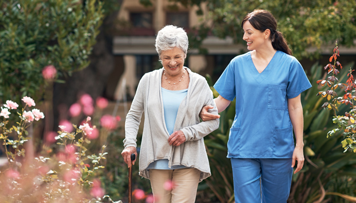 Care Worker On A Walk With Patient